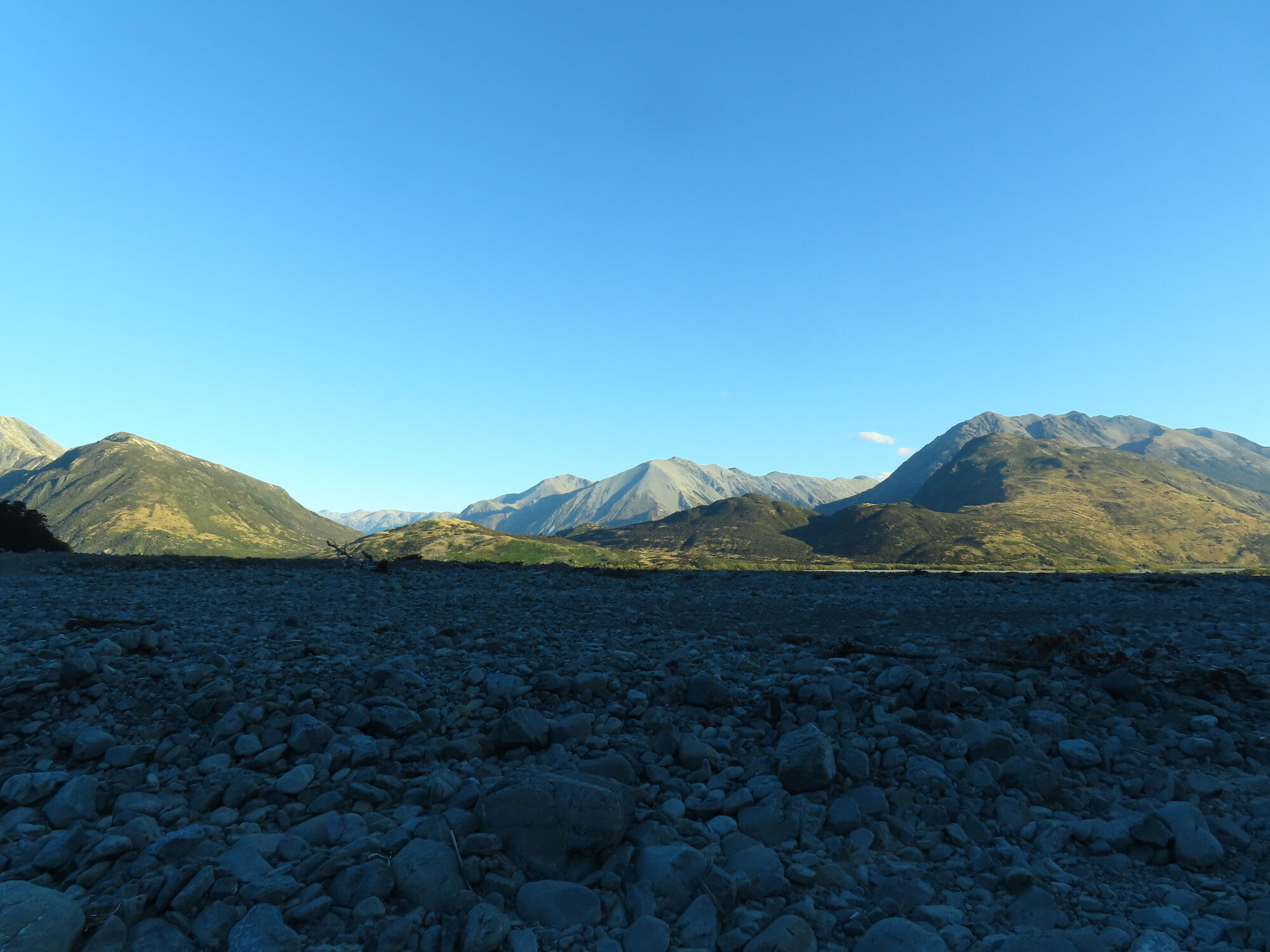Sunlit hills at dusk viewed from Hawdon River in Arthur's Pass, NZ 2026